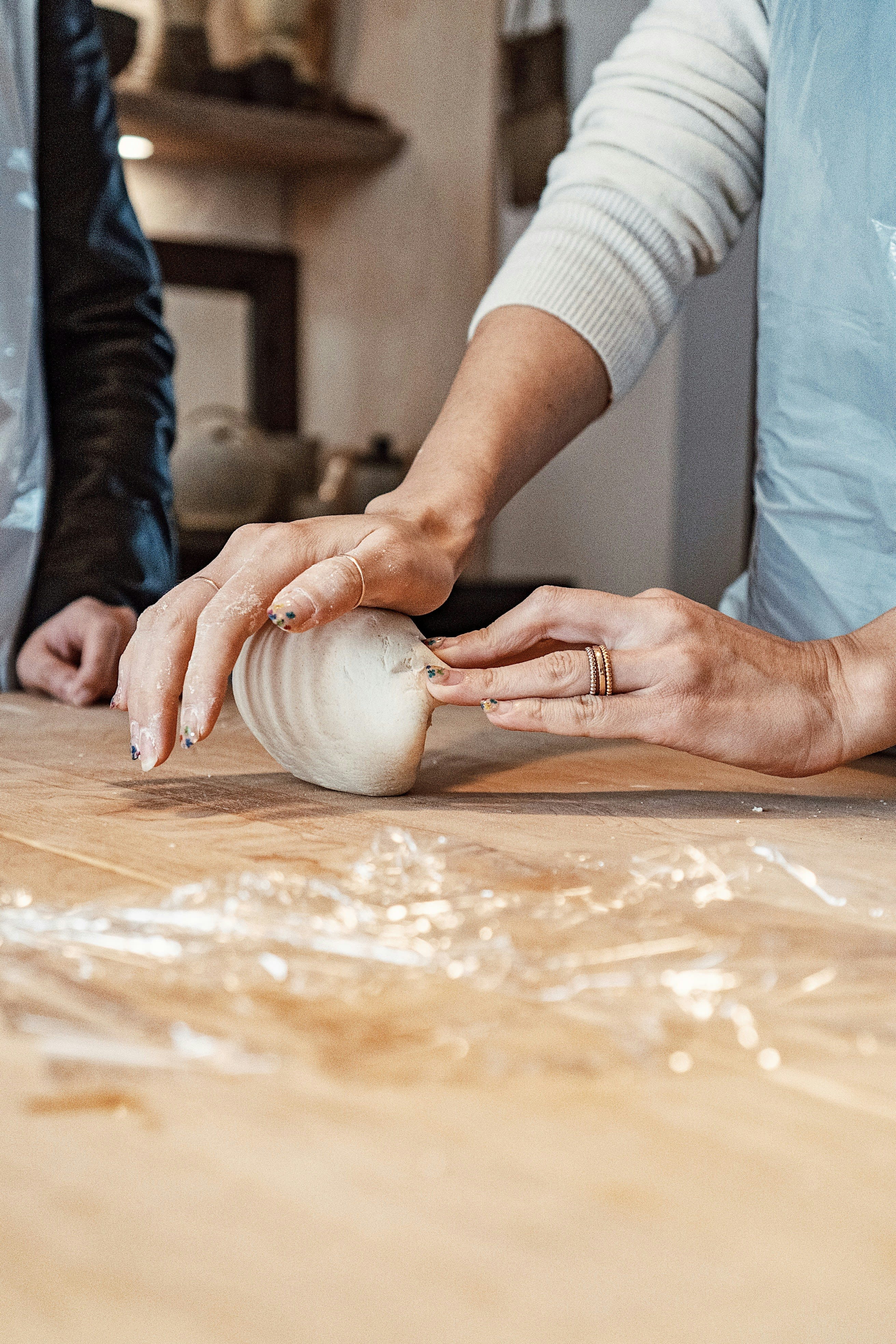a woman is peeling an onion on a cutting board
