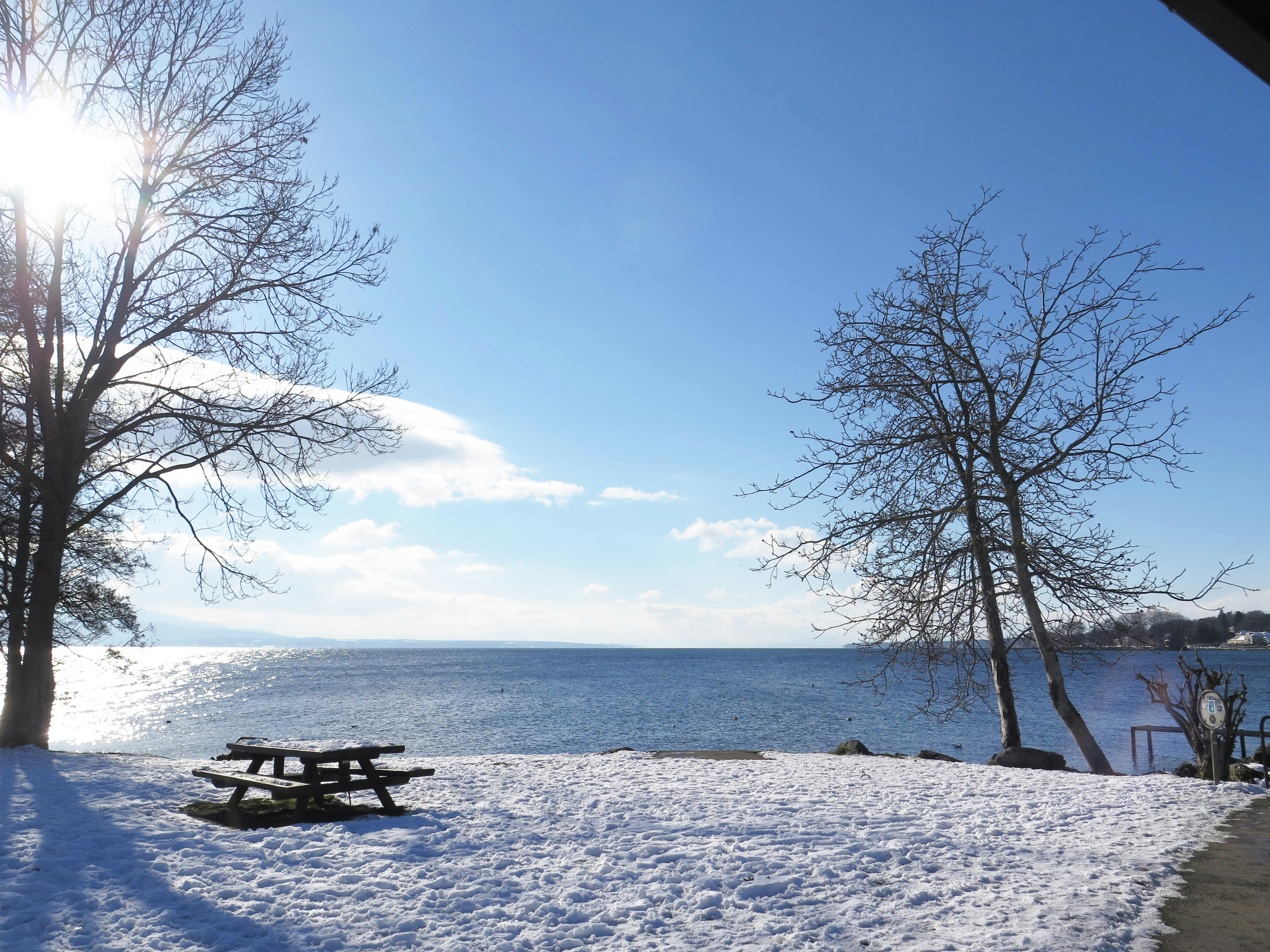 a picnic table sitting on top of a snow covered field
